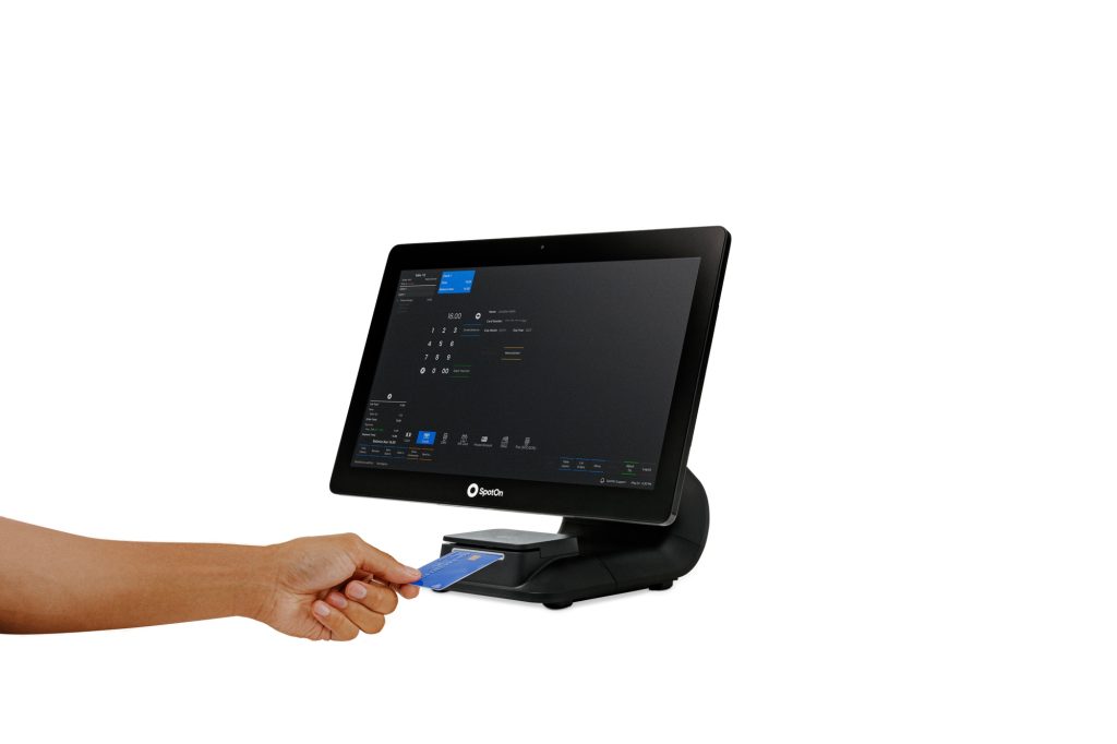 An arm putting a credit card into a POS computer