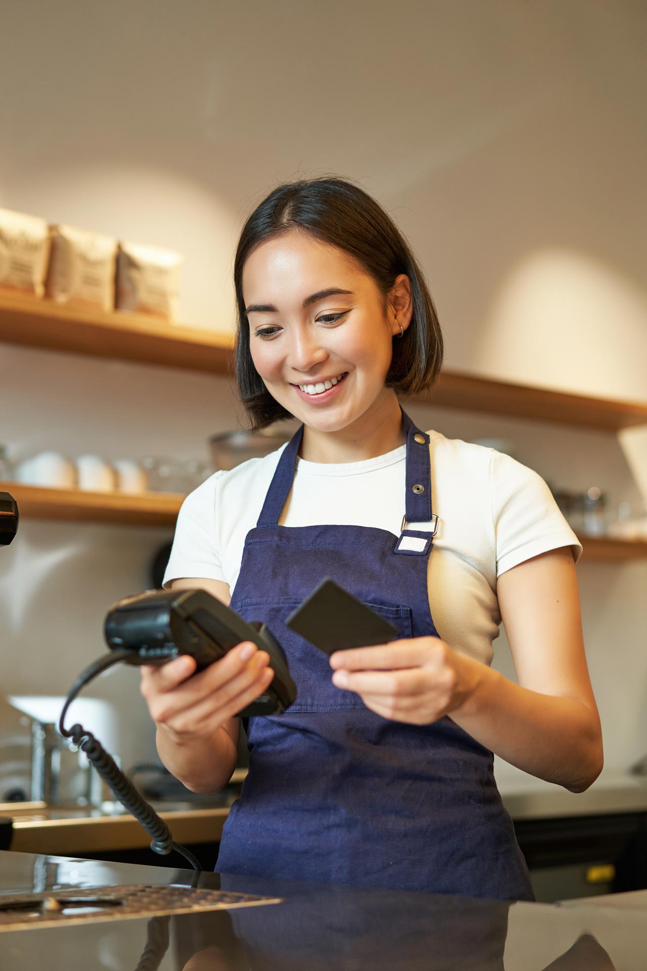 A customer running a card through a handheld POS system