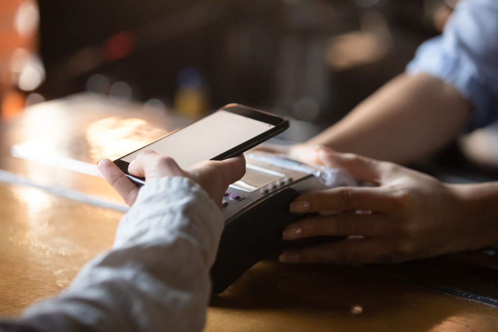 Woman,Customer,Holding,Phone,Near,Nfc,Terminal,Make,Contactless,Mobile
