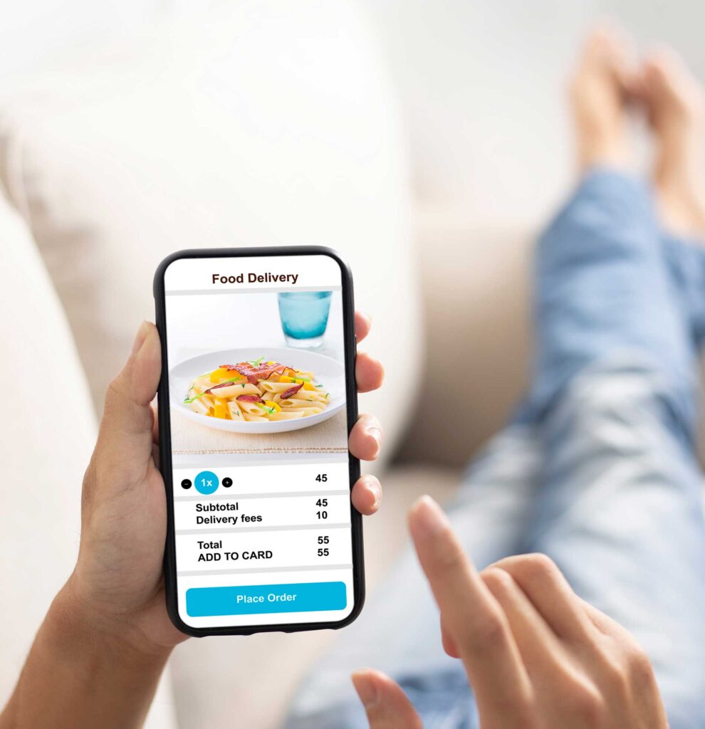 Hands holding a cellphone and ordering food delivery