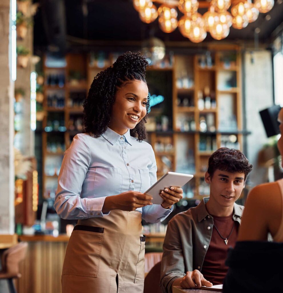 A waitress taking an order on a tablet