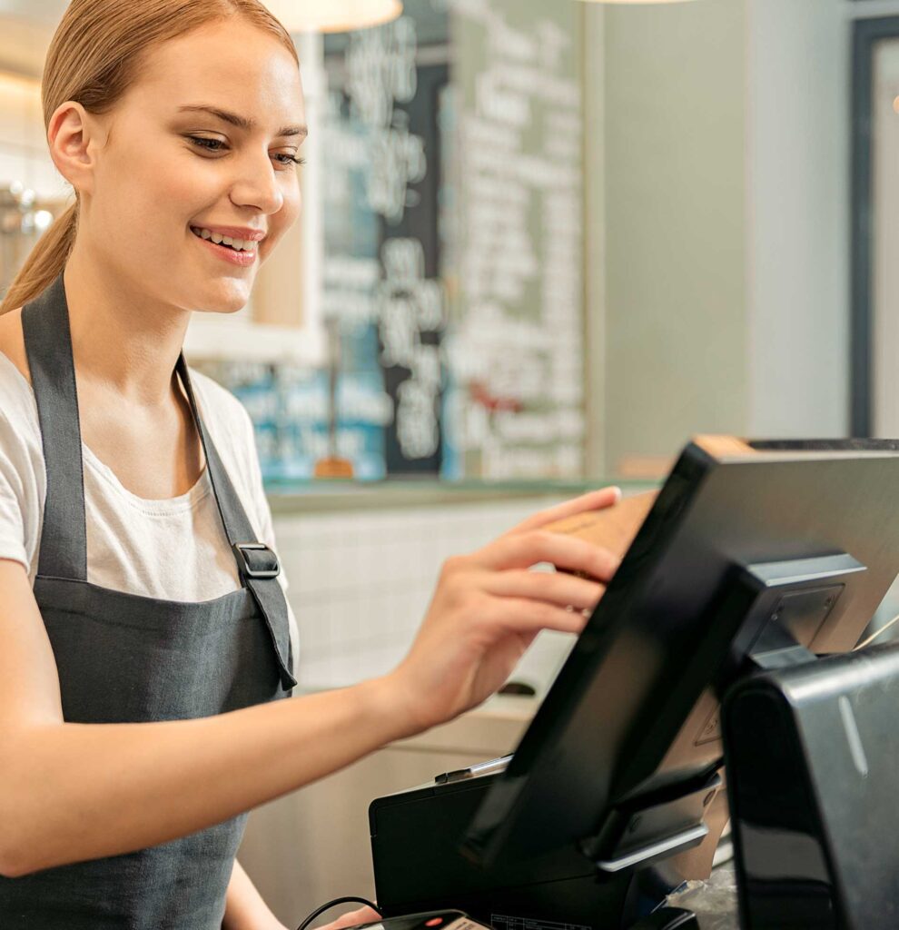 An employee inputting information on a touch-screen POS system